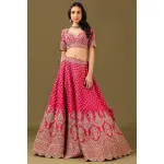 SEASONS-RANI PINK CLASSIC BRIDAL LEHENGA SET WITH ALL OVER PATTERNED HAND EMBROIDERY PAIRED WITH A MATCHING DUPATTA AND FLORAL EMBROIDERED DETAILS.